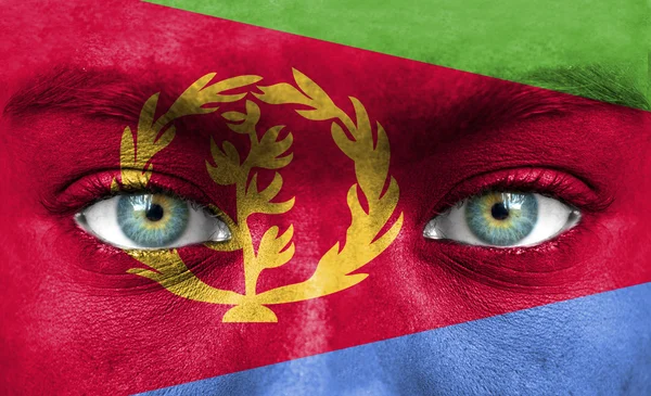 Human face painted with flag of Eritrea — Stock Photo, Image