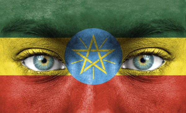 Human face painted with flag of Ethiopia — Stock Photo, Image