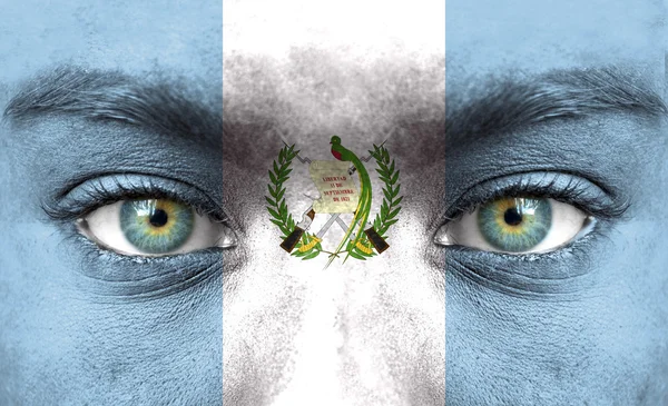 Human face painted with flag of Guatemala — Stock Photo, Image