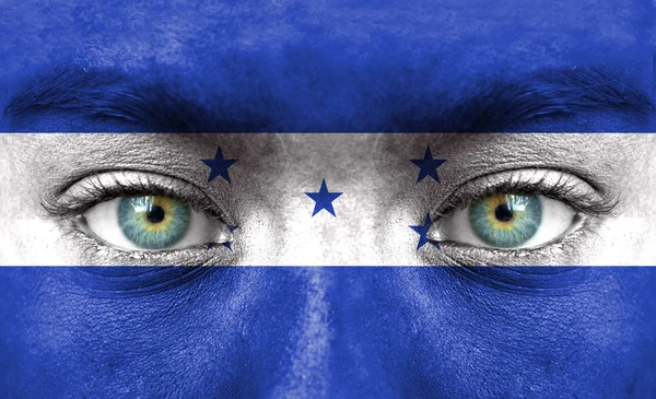 Human face painted with flag of Honduras — Stock Photo, Image