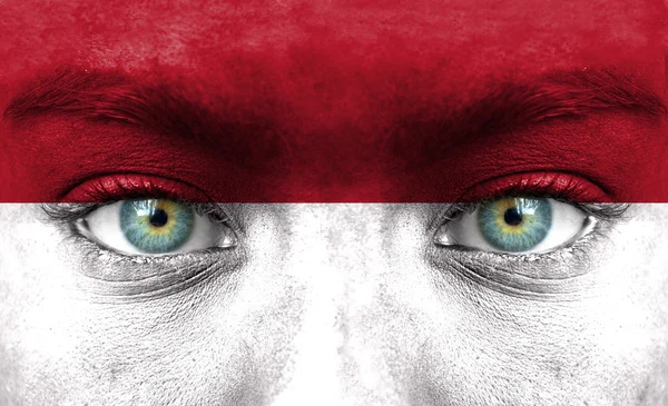 Human face painted with flag of Indonesia — Stock Photo, Image