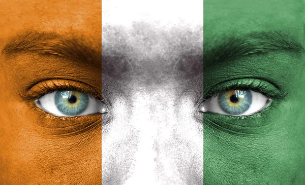 Human face painted with flag of Ivory Coast — Stock Photo, Image