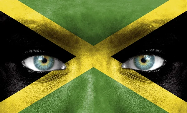 Volto umano dipinto con bandiera giamaicana — Foto Stock