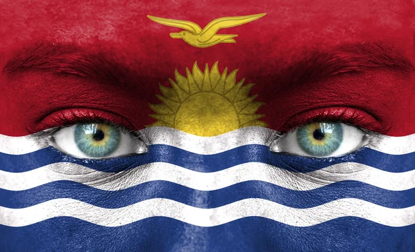 Human face painted with flag of Kiribati — Stock Photo, Image