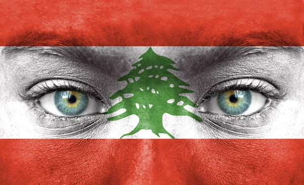 Human face painted with flag of Lebanon — Stock Photo, Image