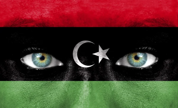 Human face painted with flag of Libya — Stock Photo, Image