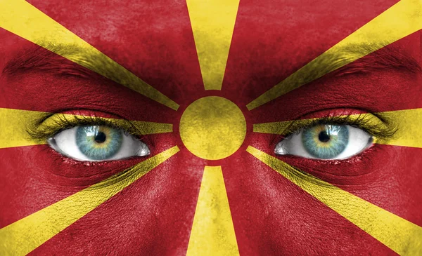 Human face painted with flag of Macedonia — Stock Photo, Image