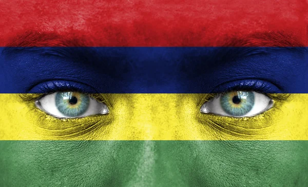 Human face painted with flag of Mauritius — Stock Photo, Image