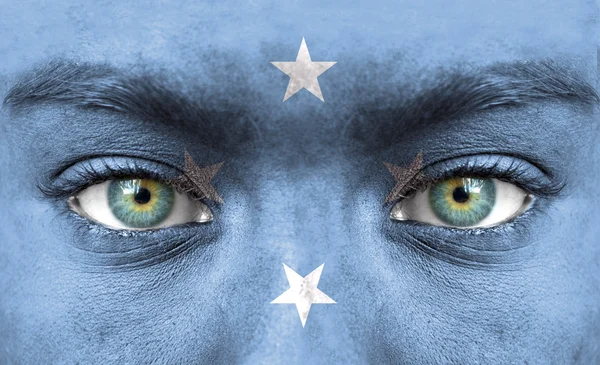 Human face painted with flag of Micronesia — Stock Photo, Image