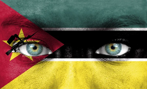 Human face painted with flag of Mozambique — Stock Photo, Image