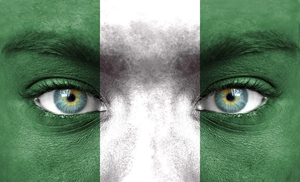 Human face painted with flag of Nigeria — Stock Photo, Image