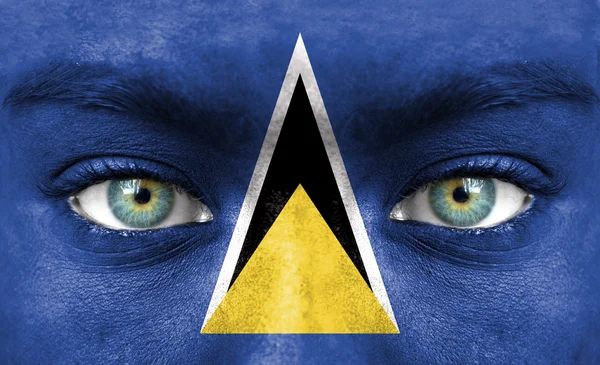 Emberi arcot festett Saint Lucia zászlaja — Stock Fotó
