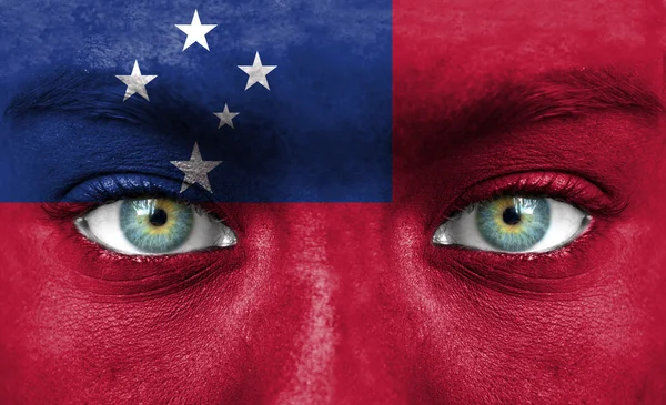 Human face painted with flag of Samoa — Stock Photo, Image
