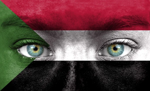 Human face painted with flag of Sudan — Stock Photo, Image