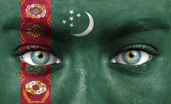 Человеческое лицо, окрашенное флагом Туркменистана — стоковое фото