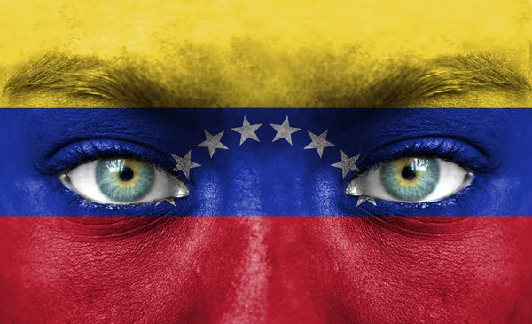 Human face painted with flag of Venezuela — Stock Photo, Image