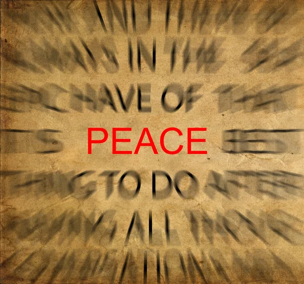 Stock image Blured text on vintage paper with focus on PEACE