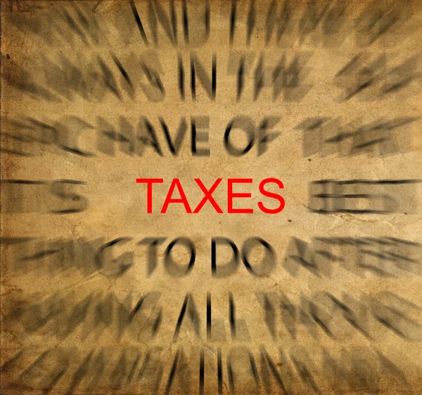 Blured tekst op vintage papier met focus op belastingen — Stockfoto