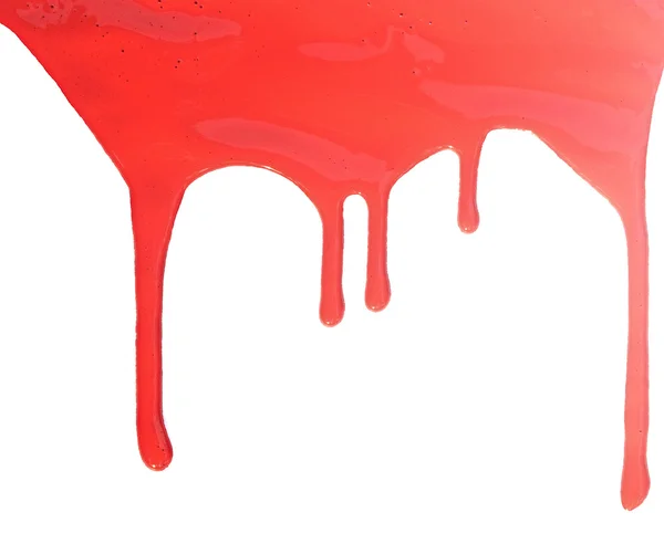 Primer plano de pintura roja que gotea sobre fondo blanco — Foto de Stock