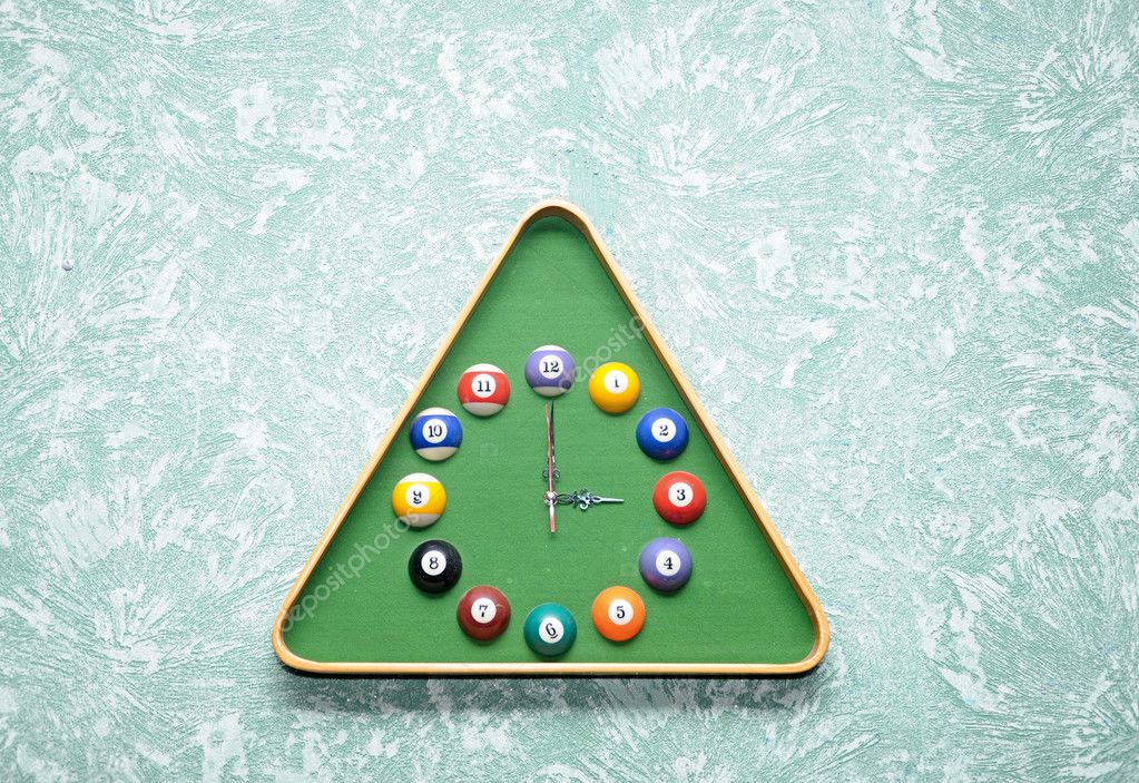 Wall clock in snooker hall in triangle frame shape
