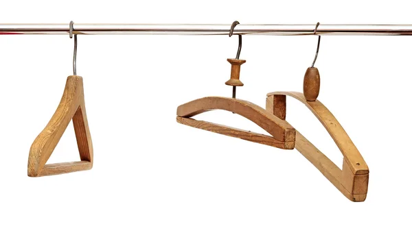 Drie kapstokken op een kleding rail — Stockfoto
