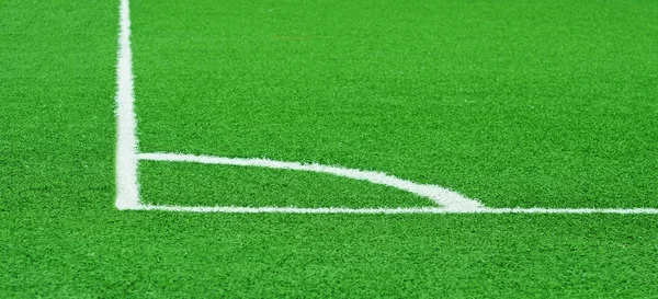 Corner of a football (soccer) field is made from synthetic lawn — Stock Photo, Image