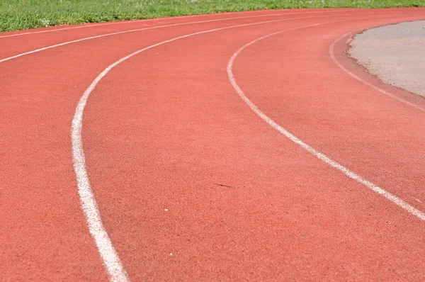 Curve on a red running track in arena — Stock Photo, Image