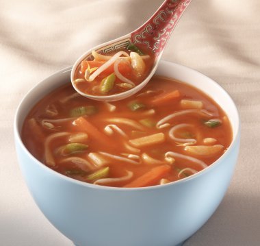 Bowl on a table with Chinese soup and a traditional spoon hoveri clipart