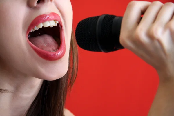 stock image Girl sings in microphone.