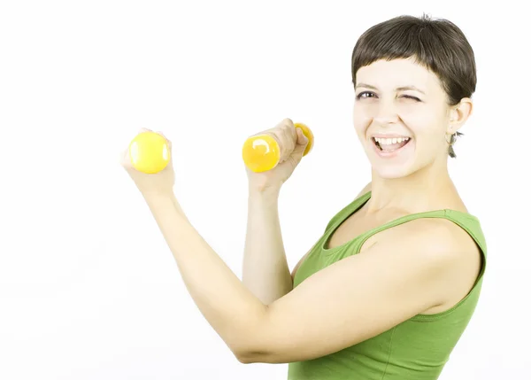 Gelukkig jonge vrouw tijdens fitness tijd en uitoefening van opheffing van halters — Stockfoto