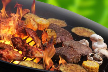 Flames grilling a steaks and vegetables clipart