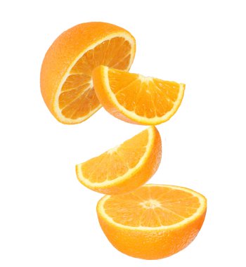 Fresh orange slices in motion over white
