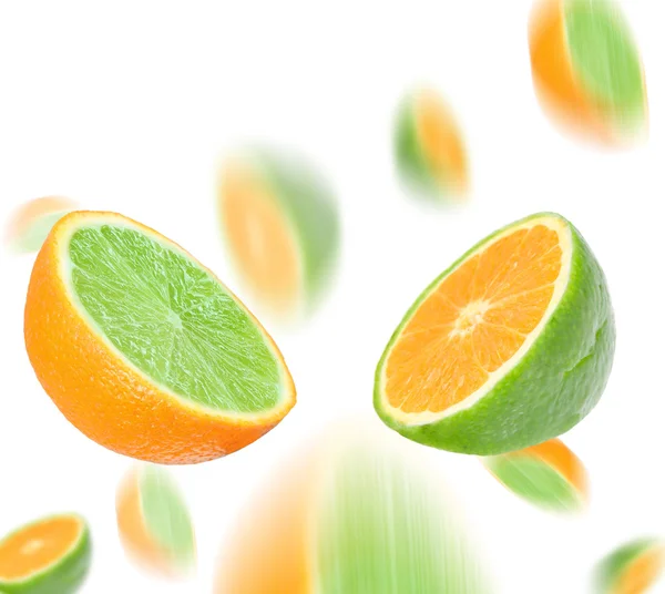 Lime in orange and orange in lime. Mixed fruit. — Stock Photo, Image