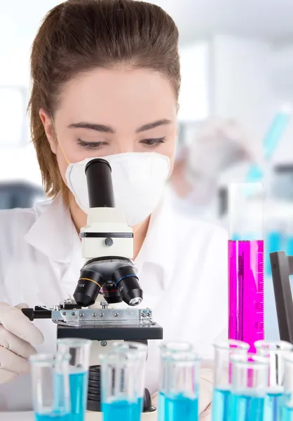 Female researcher with test tubes in laboratory — Stock Photo, Image