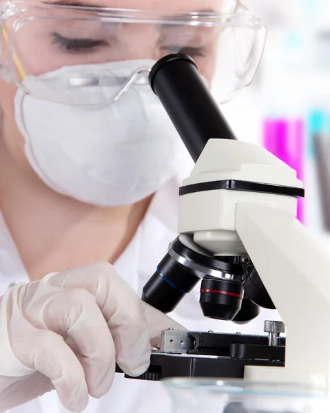Stock Photo: Scientific researcher using a microscope in a laboratory — Stock Photo, Image