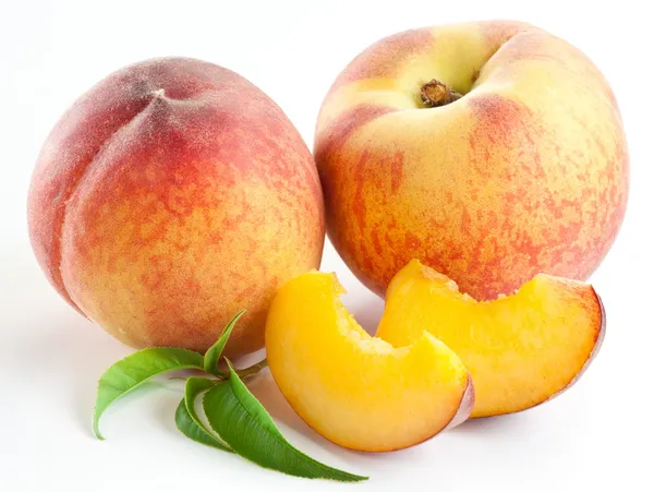 Ripe peach fruit with leaves and slises Stock Image