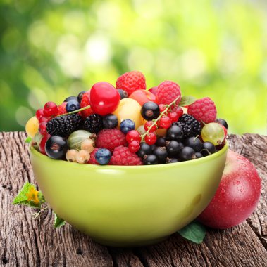 Bowl with a variety of berries clipart