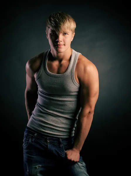 Beautiful young strong man posing on studio — Stock Photo, Image