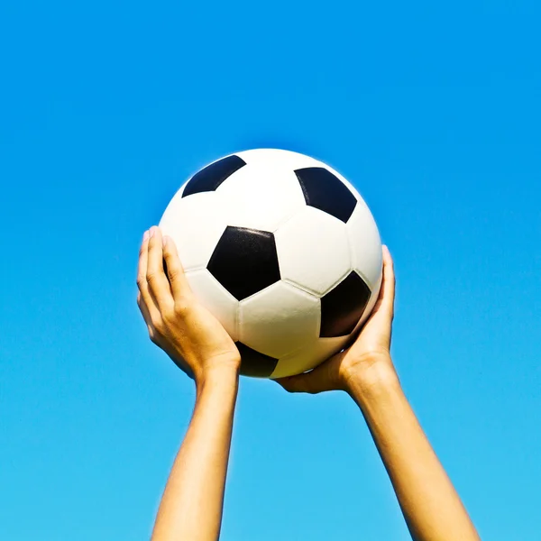Ball in hand and blue sky background — Stock Photo, Image
