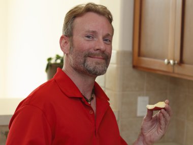 Man Holding an Apple Slice clipart