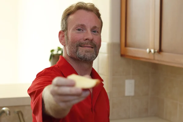Man Giving Apple Slice to Viewer — Stock Photo, Image