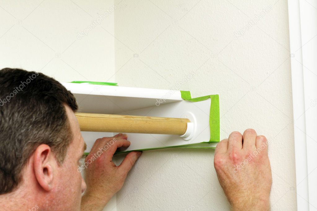Man Applying Green Painter's Tape