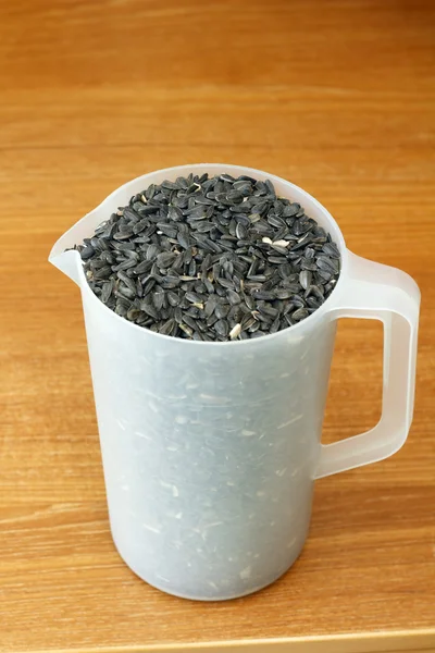 Pitcher of Black Sunflower Seeds — Stock Photo, Image