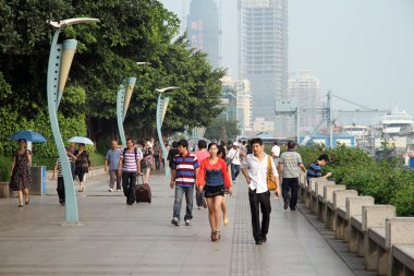 Peole are walkin on the quay in Xiamen clipart