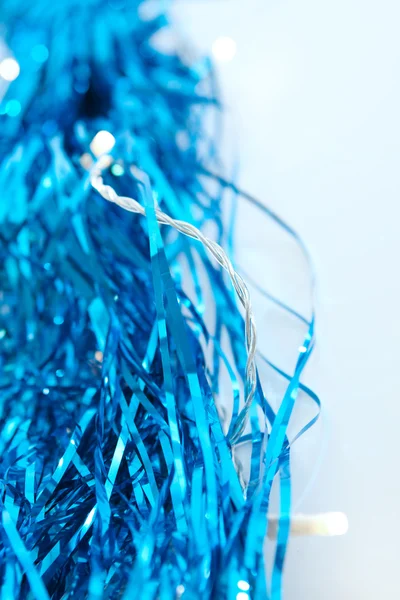 Blue tinsel and Christmas lights — Stock Photo, Image