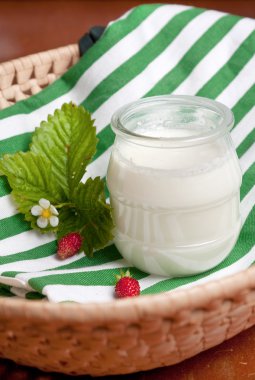 Glass pot of creamy natural yoghurt clipart