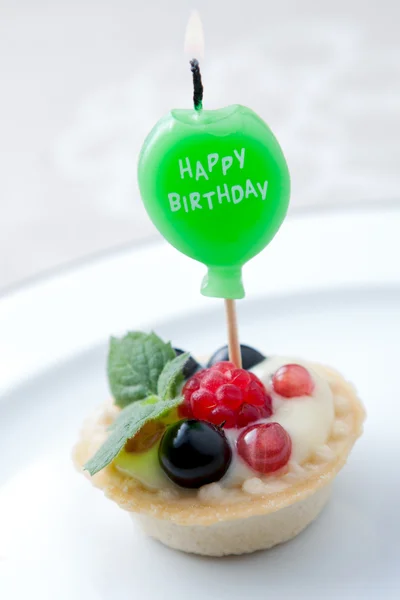 Birthday candle in fruit tart — Stock Photo, Image