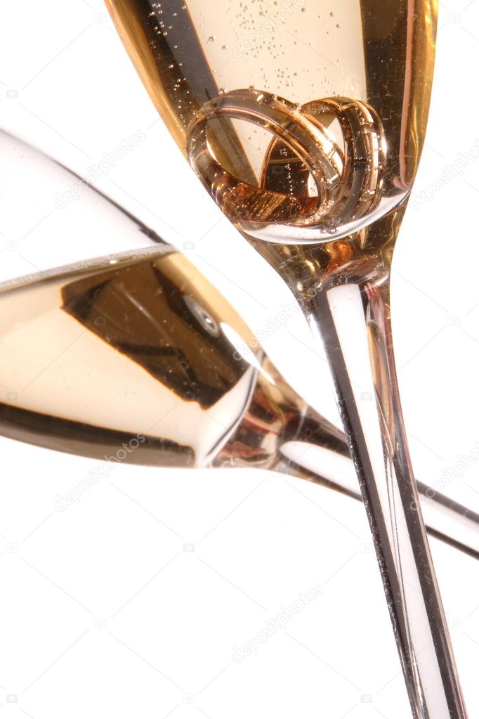 Pair of engagement ring in champagne glass
