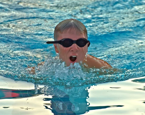 Um menino pré-adolescente nadando — Fotografia de Stock