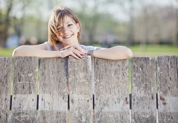 Girl by the fence — Stock Photo, Image
